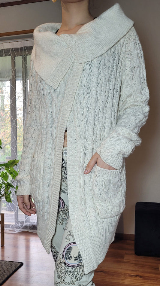 beige knit cardigan with a high neck and long sleeves, in good preloved condition available in size small-medium.