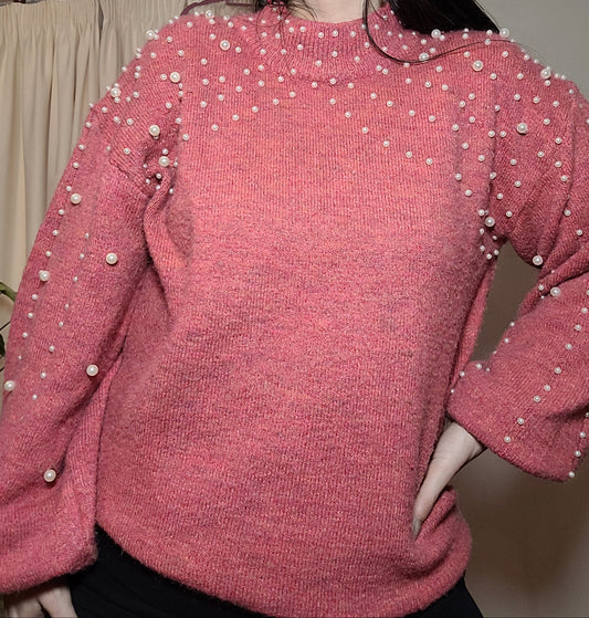 pink sweater, v-neck, long-sleeved sweater with a textured pearl-like pattern, made of wool and acrylic, posing against a white background in second hand condition. size large