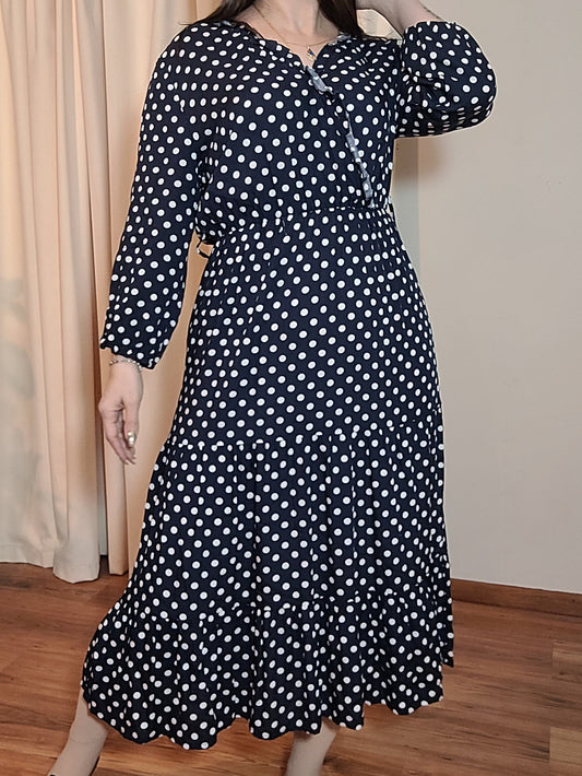 A preloved navy dress with white polka dots, featuring a wrap neckline and a maxi skirt design, in good preloved condition. Size