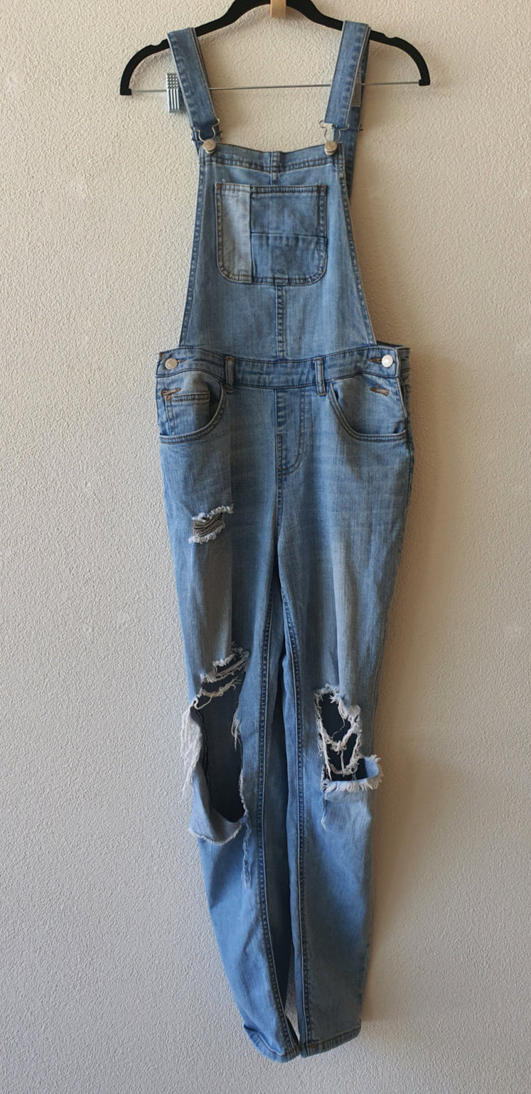 A preloved blue ripped denim jumpsuit Cute Ripped Overalls in good preloved condition. size 8 available at our online second hand store paothrift.co.nz