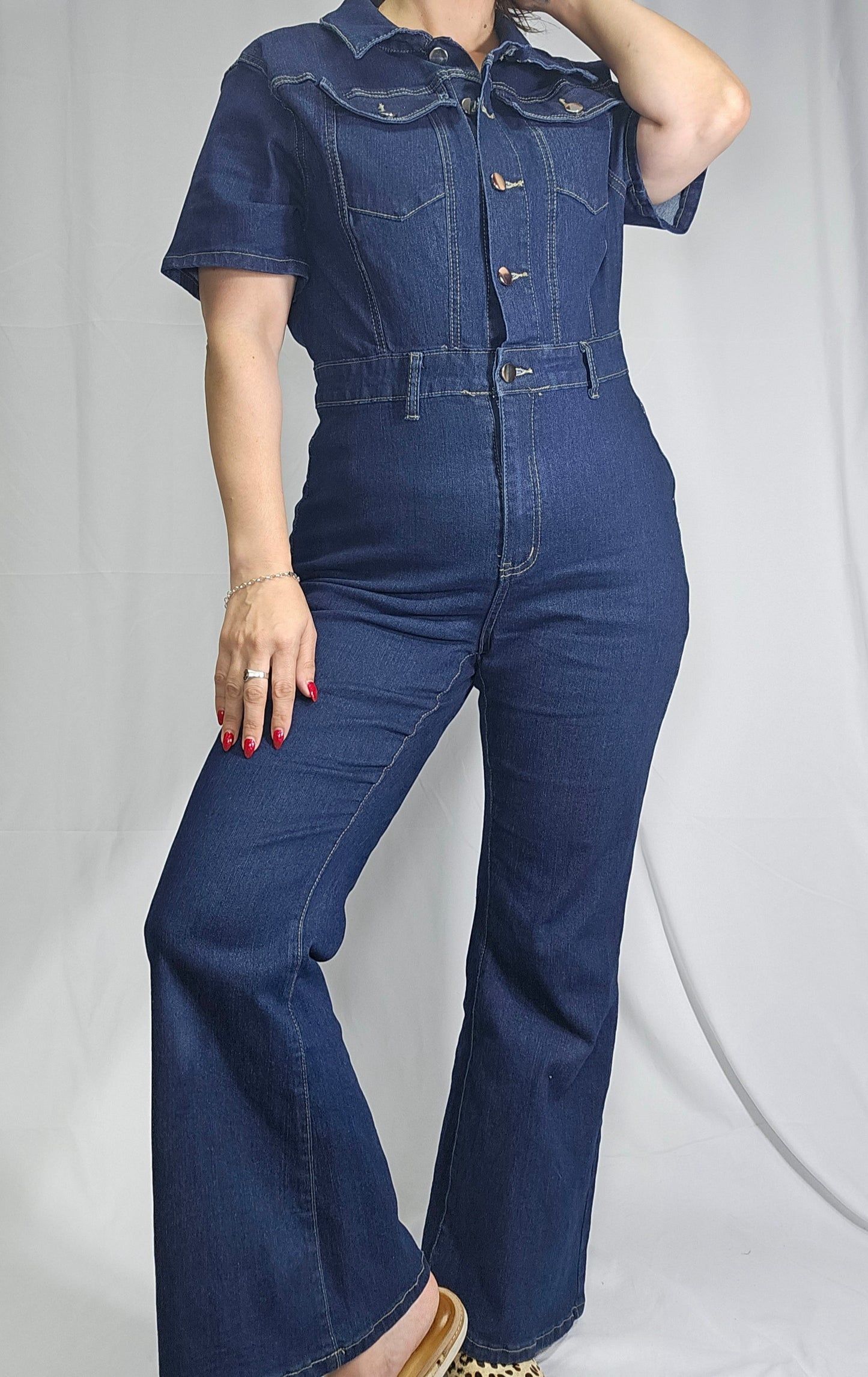 preloved blue denim jumpsuit with flared legs and short sleeves, size 10-12 medium large. in good used condition in Auckland in a second hand store.