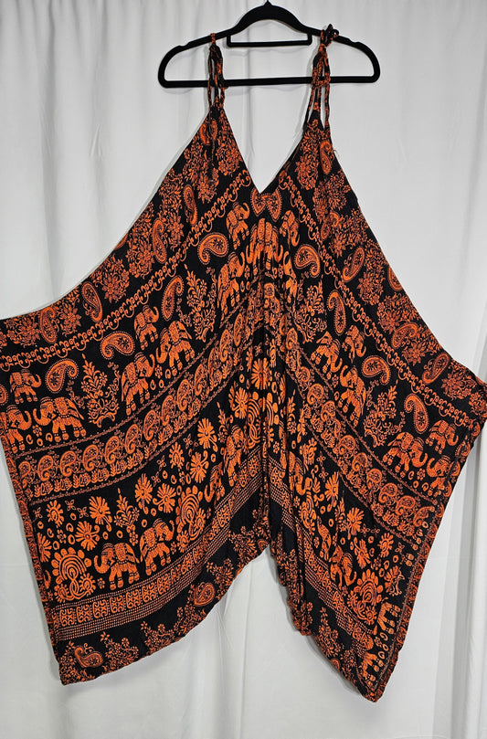 A hippie bohemian style jumpsuit with a balloon style silhouette, featuring a hippie pattern in muted colors. one size fits all. in good preloved condition