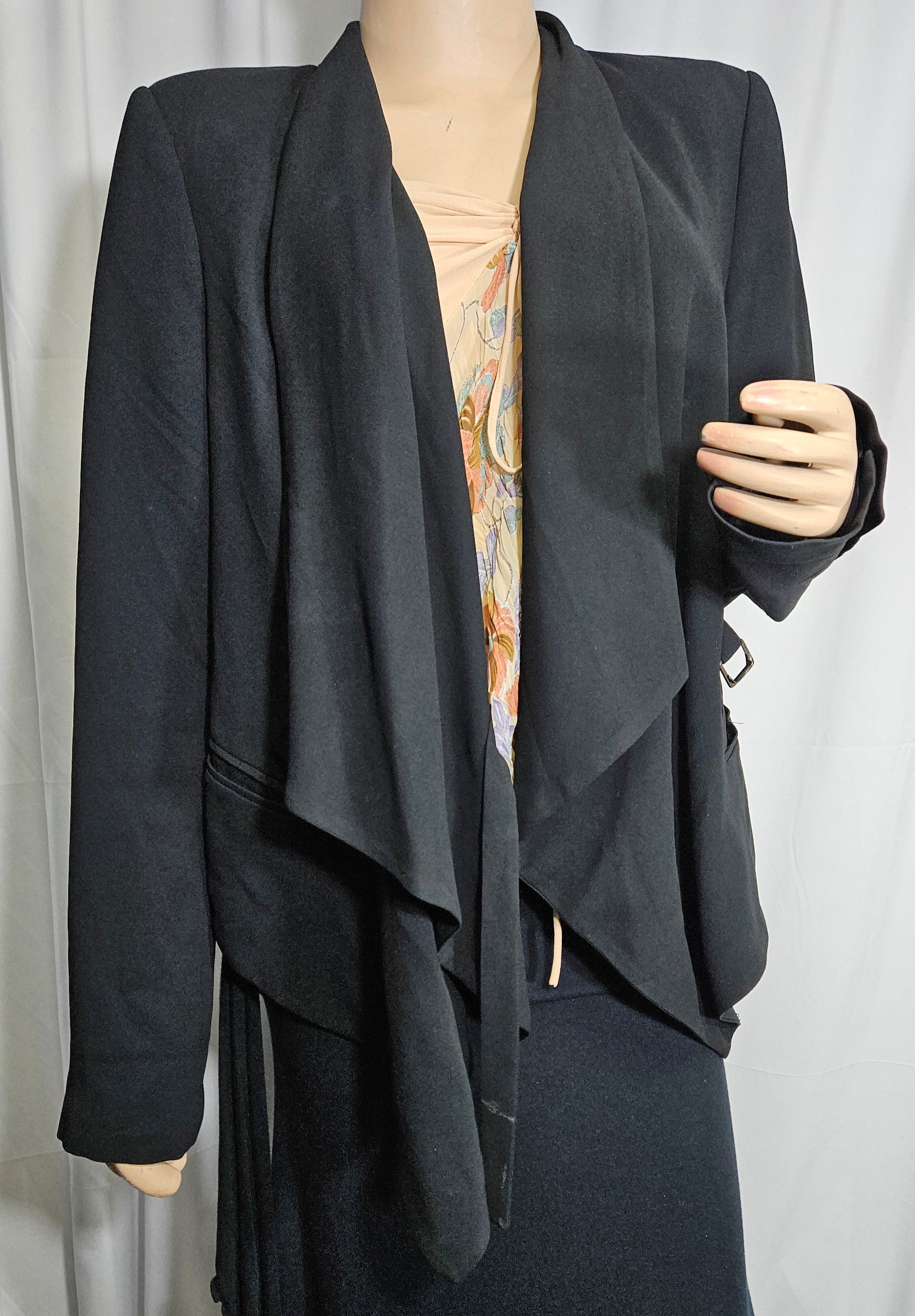 A black asymmetrical blazer jacket with button details and a collar, in good preloved condition. Size 14