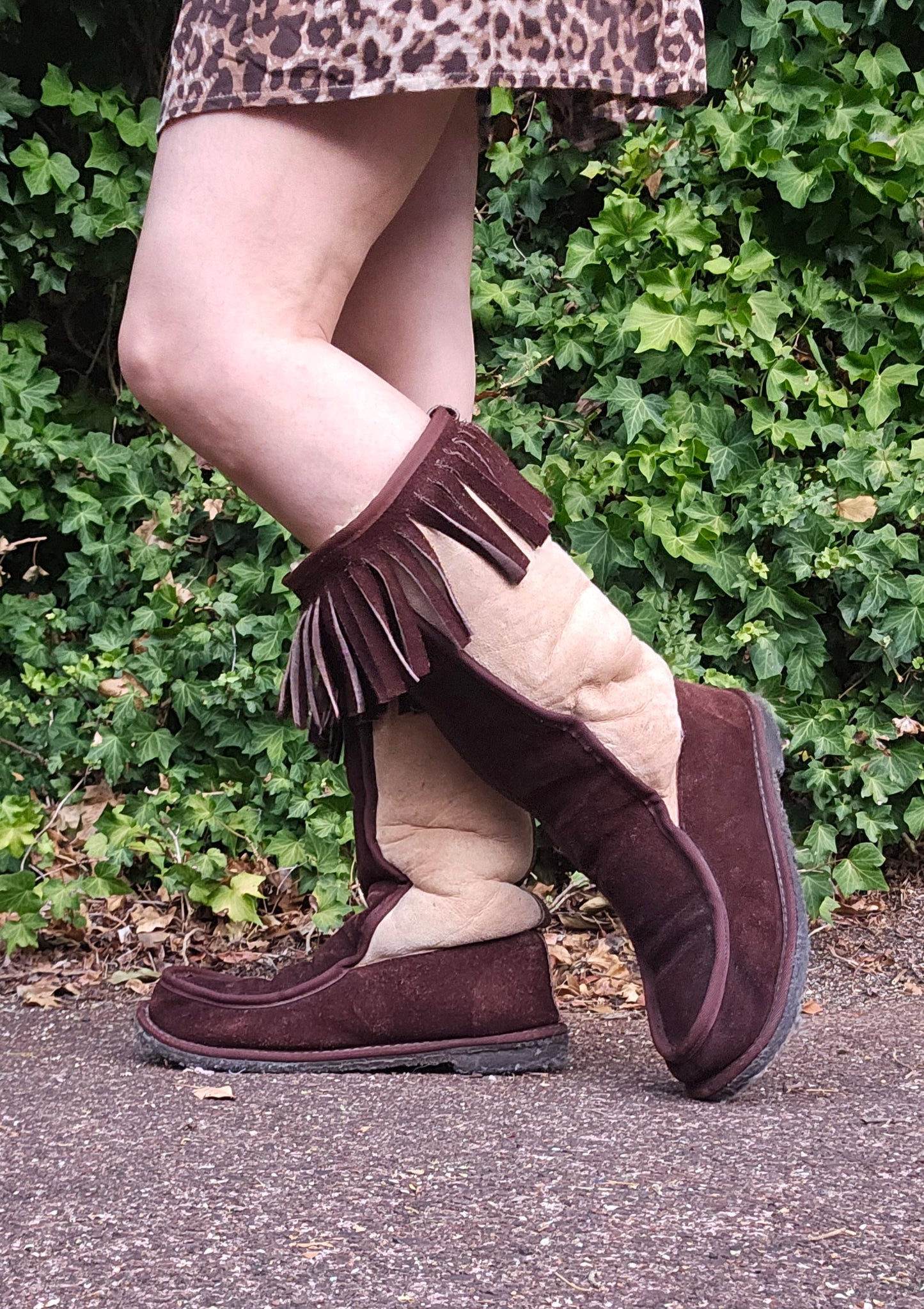 Warm and congenial, this creation is particularly embellished with a series of fringes on both side and a double buckle straps. wool lamb skin boots