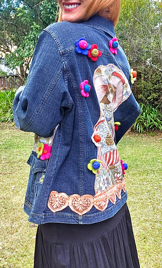 vintage denim jacket with floral details and retro doll embellishments. size large