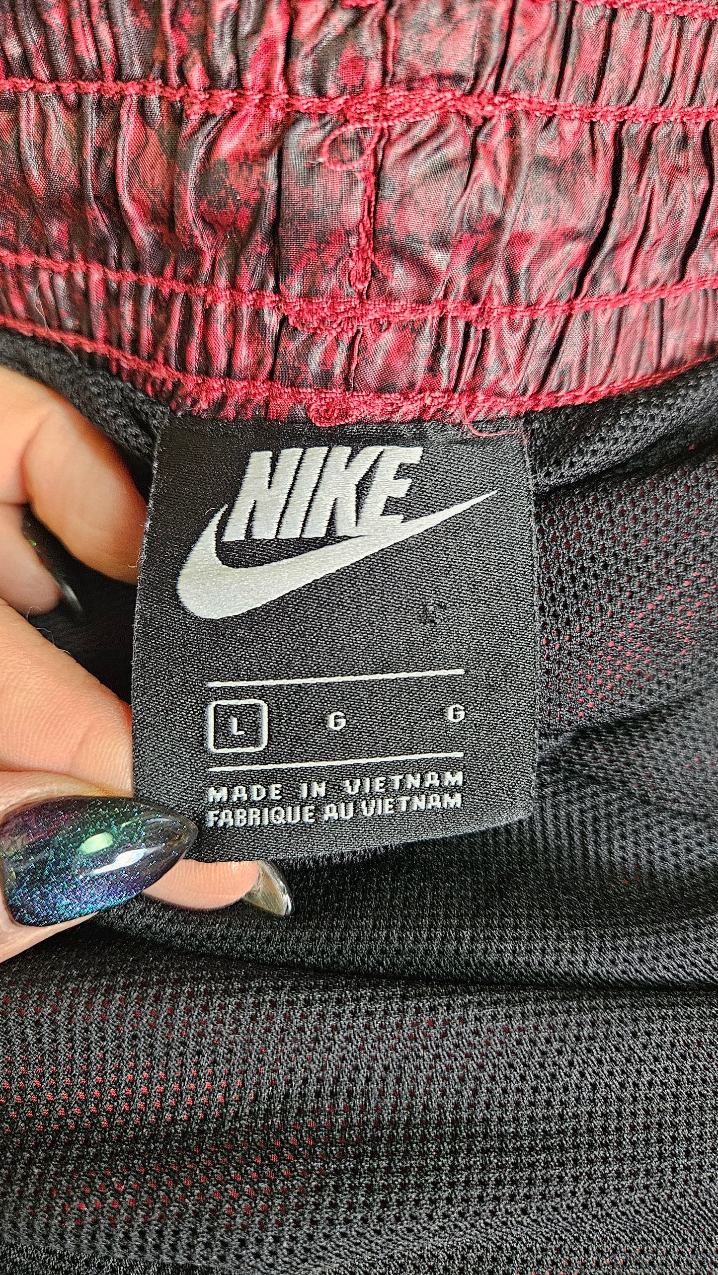 Nike nylon track pants. Red and black snakeskin pattern. in preloved condition size LArge