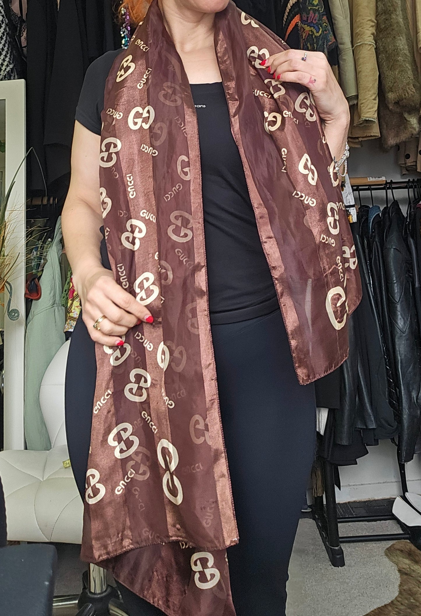 brown scarf with a gucci pattern, in a secdond hand clothing store. in preloved condition in Auckland