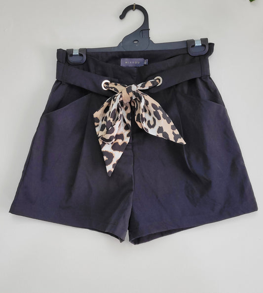 Black high-waisted shorts with pockets and a leopard print bandana tied around the waist in good preloved condition.