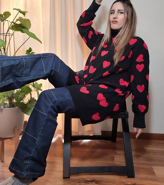 black long-sleeve sweater with a red heart pattern size large in good preloved condition available in a online second hand store