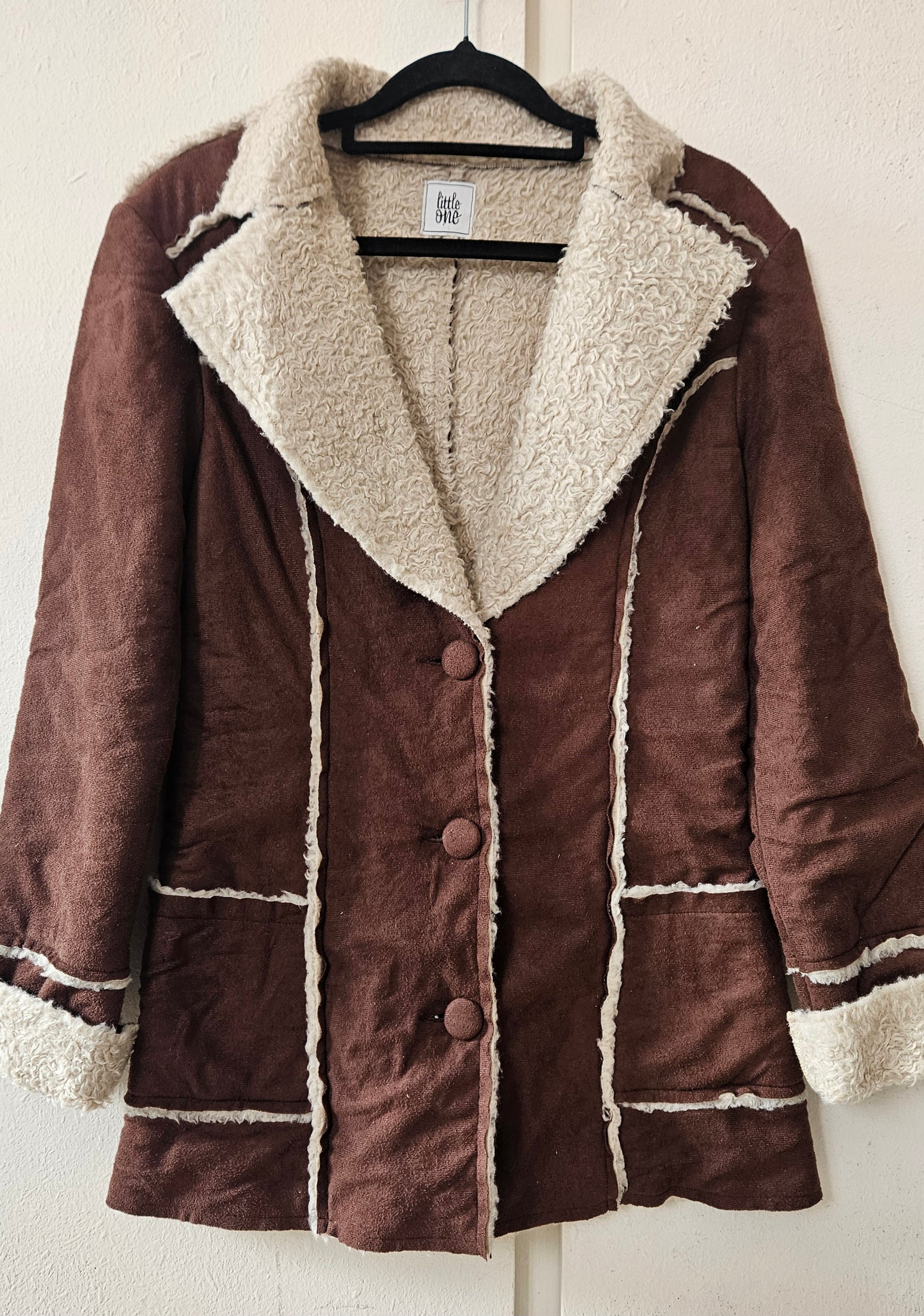 Button up Brown coat with white fur trim by little one brand in good preloved condition available in Auckland for sale.