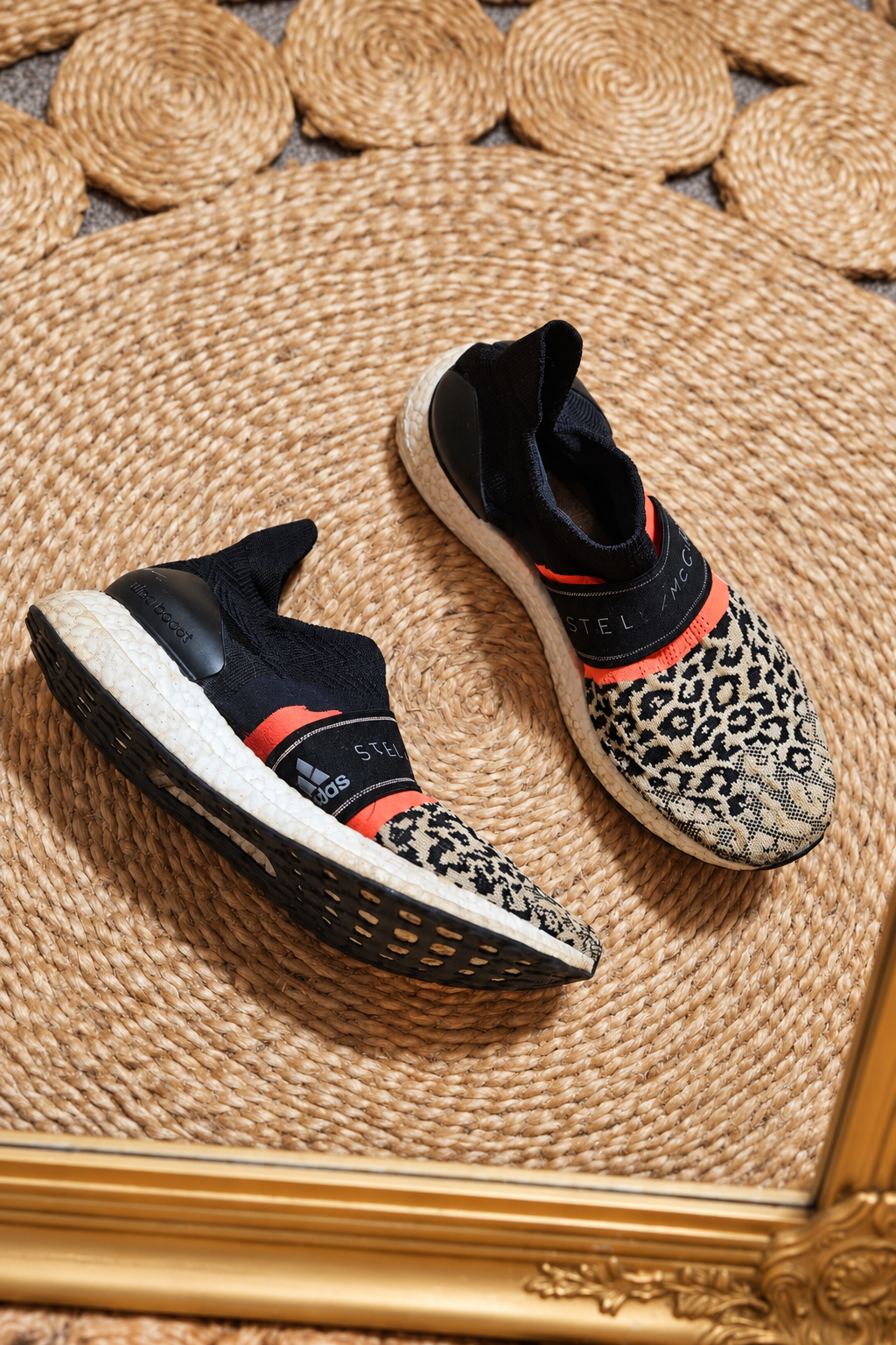Adidas by Stella McCartney UltraBoost 3D Knit Leopard sneakers in black and beige animal print with coral accents, preloved condition.