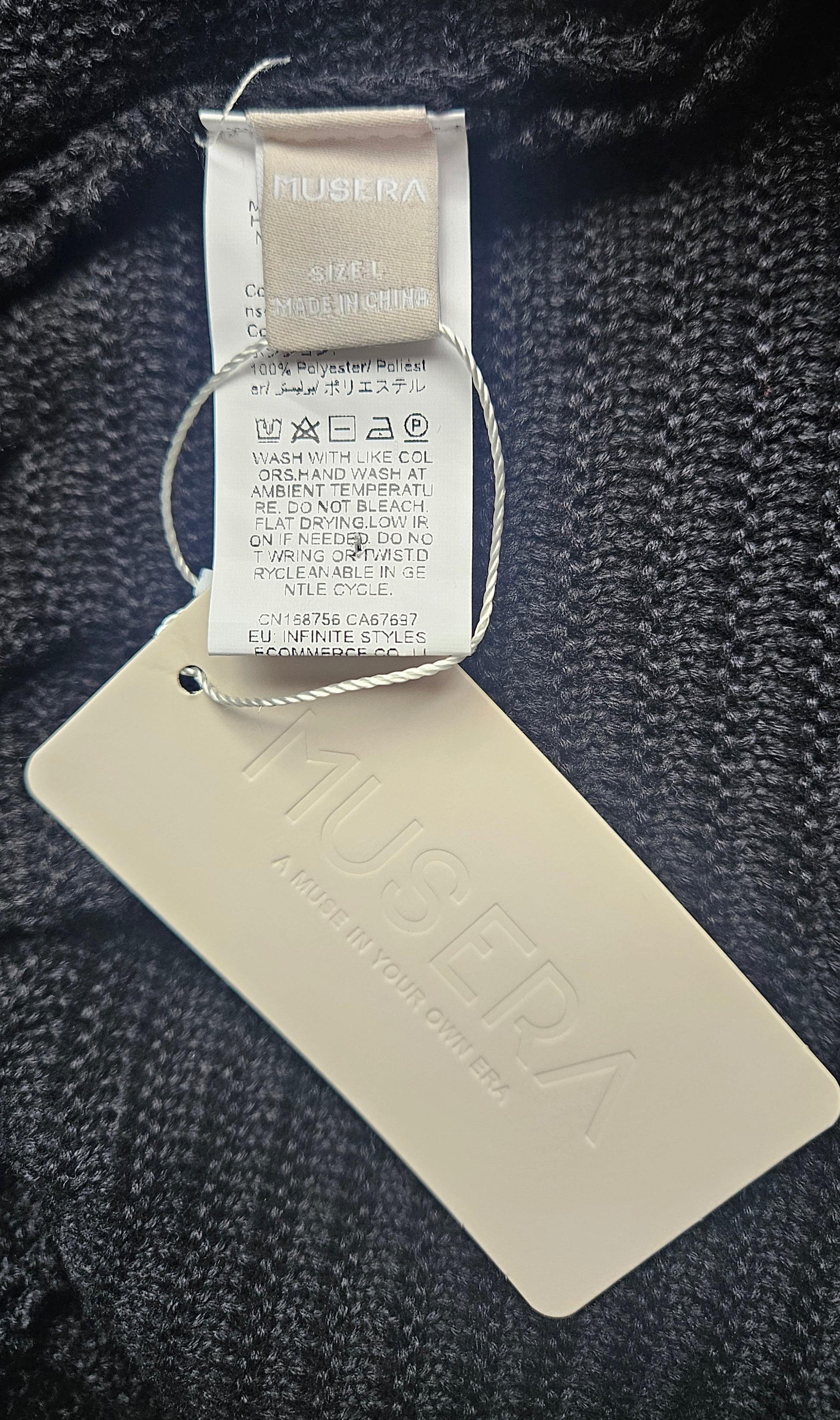 musera tags on a textured fabric background. knit dress Size L